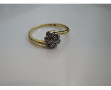 A diamond flower head ring, set with seven old-cut diamonds, in unmarked gold, size O