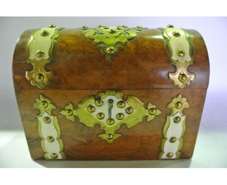 A good quality Victorian burr walnut chest shaped caddy with extensive applied brass mounts, lock escutcheon and central meda