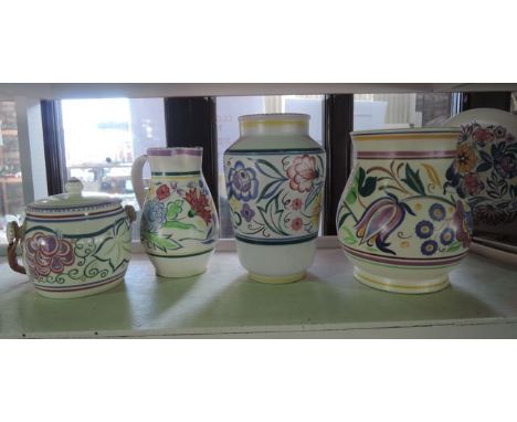 A collection of Poole Pottery wares comprising a vase with bluebird and floral design with painted mark to base X/TV, a furth