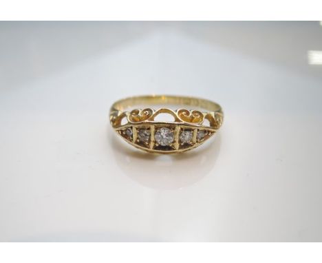 An Edwardian style diamond ring, Chester, 1912, centred with five graduated old-cut diamonds, with scrolling details, in 18ct