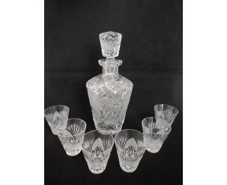 A heavy clear cut decanter of tapering mallet form with extensive and intricate star and other cut decoration, complete with 