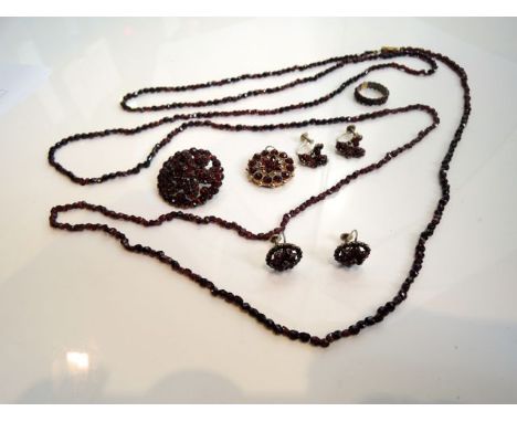 A selection of 19th century Bohemian garnet jewellery, comprising: a brooch, a ring and two pairs of earrings, with screw fit