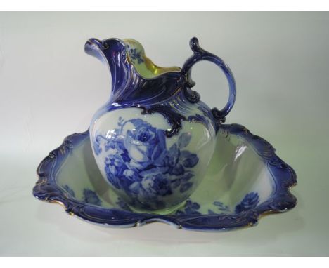 A Doulton Burslem blue and white printed jug and basin set in the Gloire-de-Dijon pattern with rose decoration to the interio