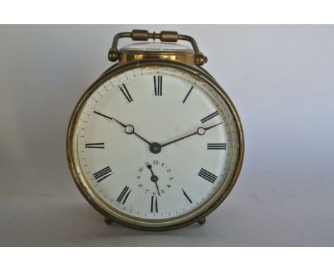A Victorian brass bedside clock with drum shaped case and 8 day movement with alarm