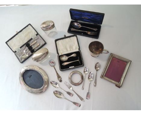 A cased silver Christening set, Sheffield, 1915, comprising: a fork and a spoon, 67.4g; an Edwardian silver easel back pictur