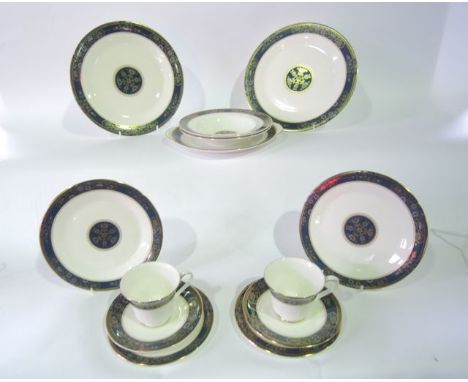 A quantity of Royal Doulton Carlyle pattern dinner and tea wares with dark green, blue and gilt border decoration number H501