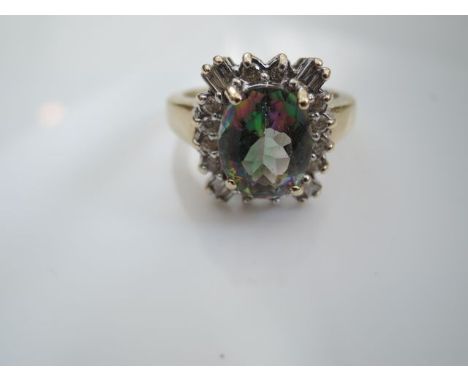 A gem-set ring, centred with an oval mixed-cut probably mystic topaz, highlighted with round brilliant- and tapering baguette