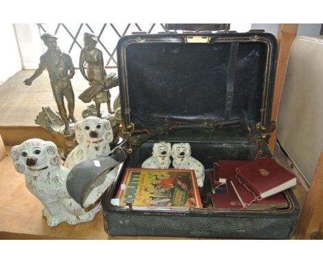 A vintage leather Gladstone type case together with one large and one small pair of Staffordshire type ceramic models of seat