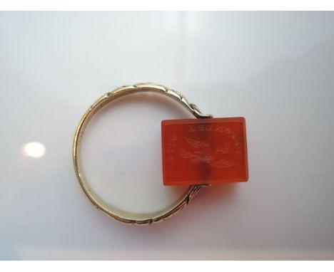 A swivel seal ring, centred with a rectangular cornelian engraved "Repondez Vite" on one side and "Caroline" on the other, in