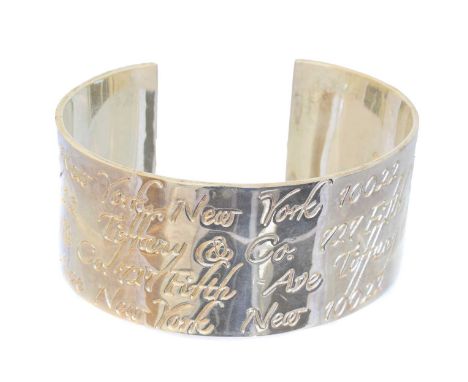 A silver cuff bangle by Tiffany &amp; Co., engraved with New York script, signed Tiffany &amp; Co., dated 1997, inner diamete