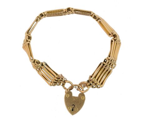 An early 20th century 15ct gold bracelet, the gate link chain with heart shape padlock clasp, stamped 15ct, length 19cm, gros