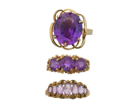 Three 9ct gold amethyst dress rings,  to include a single stone ring, a five stone ring and a seven stone ring, ring sizes Q 