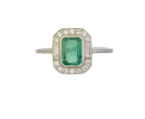 An emerald and diamond cluster ring, the rectangular shape emerald within a brilliant and baguette cut diamond surround, esti