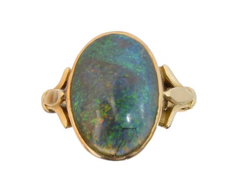 An 18ct gold boulder opal ring, the oval boulder opal cabochon with tapered shoulders, hallmarks for Sheffield, ring size X1/