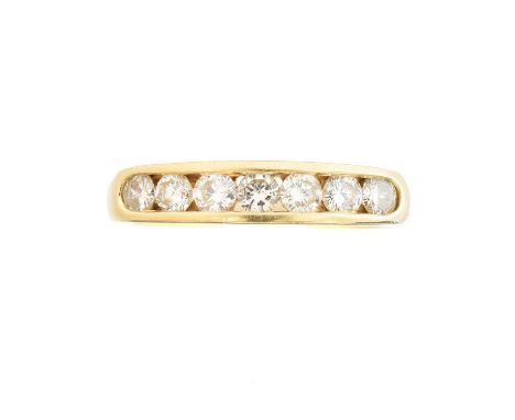 An 18ct gold diamond band ring, the brilliant cut diamond line inset to the polished band, estimated total diamond weight 0.7