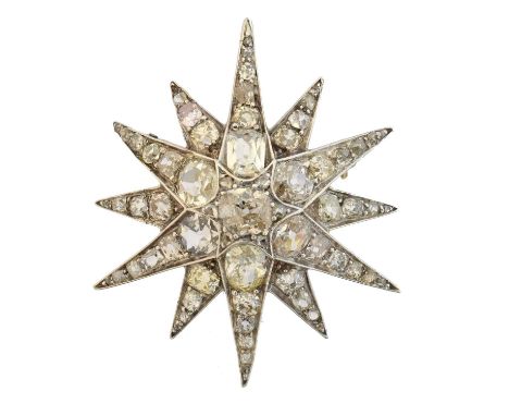 A diamond star brooch, designed as a six ray star set with vari-cut diamonds and similarly cut diamond spacers, estimated tot