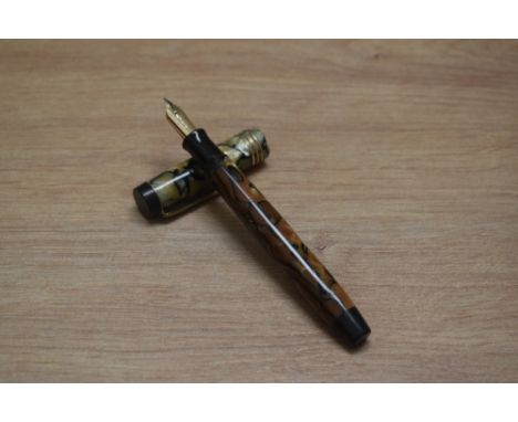 A Parker Duofold Lucky Curve Deluxe Senior button fill fountain pen in black and pearl with three cap bands having a Parker D