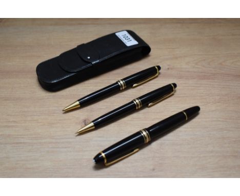 A Montblanc Meisterstuck 146 piston fill fountain pen, ballpoint pen and propelling pencil in black with gold trim, the fount