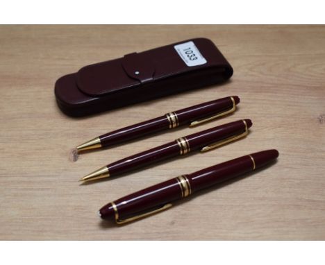 A Montblanc Meisterstuck 146 piston fill fountain pen, ballpoint pen and propelling pencil in burgundy with gold trim, the fo