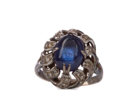 SAPPHIRE AND DIAMOND RING, set with a cabochon sapphire to an openwork diamond setting, the round brilliant cut diamonds tota