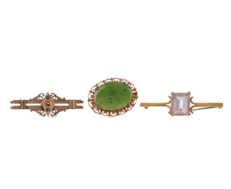 JADE BROOCH, the cabochon jade within an openwork scrolling mount, marked 9CT, 6.2g, along with a nine carat gold red gem set