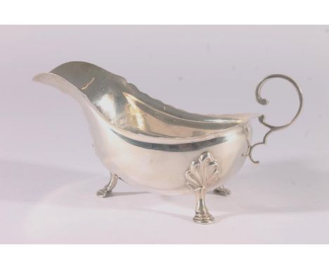 George V silver sauce boat, with shaped rim, open scroll handle and shell shouldered pad feet, Harrison Bros &amp; Howson, Sh