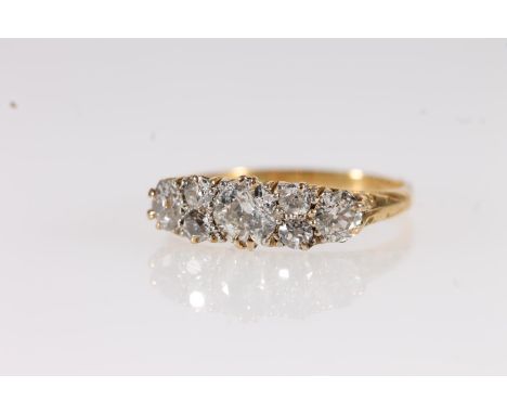 Edwardian 18ct gold and seven diamond ring, the seven round cut graduating stones approximately 0.9 to 1.0ct total, ring size