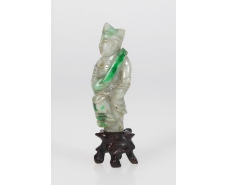 A 19th century celadon green jade figure of a scholar holding a scroll whilst balancing on one foot, the scroll and raised le