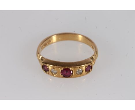 18ct gold ruby and diamond ring, the round cut rubies and diamonds bezel prong set in a raised block mount with bow embossed 