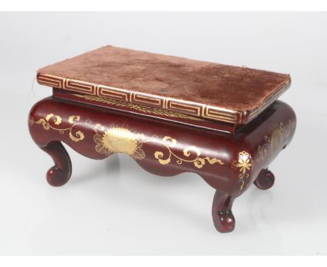 19th century Chinese brown and gilt lacquered stand with deep apron and supported on scroll feet, 18cm x 12cm x 9.5cm (h).