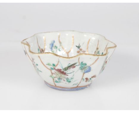19th century Chinese famille rose lobed bowl with floral and insect decoration, two incised marks to the base, gilded rim 11.