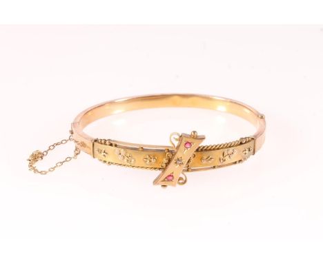 Edwardian 9ct gold ruby and diamond set bangle, 7.2g gross.