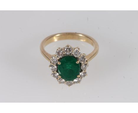 18ct gold, emerald and diamond cluster ring, the oval cut emerald within a halo of round cut diamonds, prong set on a basket 