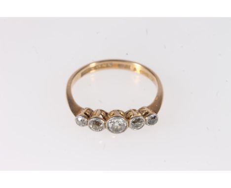 18ct gold and platinum diamond five stone ring, the central 0.25ct diamond flanked by smaller stones, makers mark 'L & Sons' 