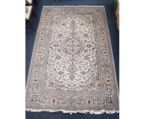 Persian Kashan carpet rug, cream ground with central shaped foliate medallion surrounded by further floral motifs and designs