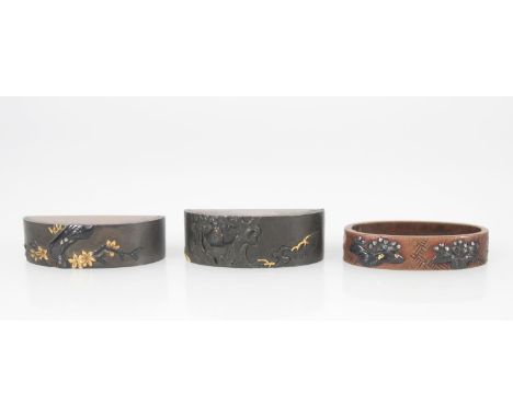Three miscellaneous kodogu (sword fittings), a fuchi with bronze autumn leaves and silver berries on a distressed woven groun