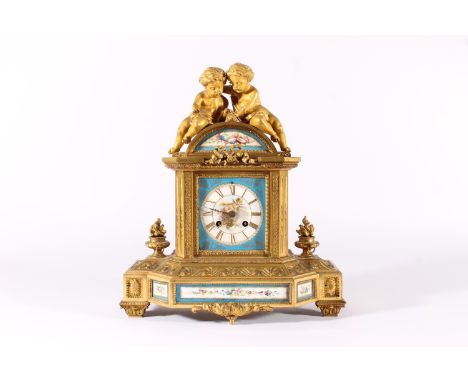 French gilt metal and porcelain mantel clock, 19th century, surmounted by two putti over dome enamel painted frieze, the enam