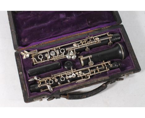 Oboe by F. Lorée of Paris, with silver plated keys and stamped F. Lorée, Paris no. FF 25, purple velvet lined leather case.&n