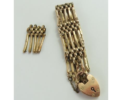 A five bar gate bracelet, with patterned connecting links and heart padlock, marked '9c', with a spare link, 19.2g gross, in 