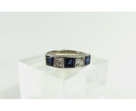 A beautiful Art Deco style 18ct white gold sapphire and diamond five stone ring, the three square cut sapphires with round br
