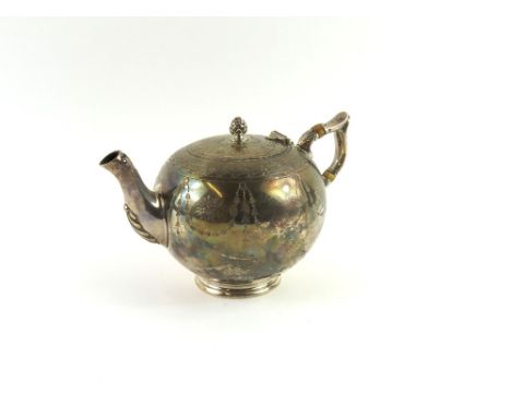 A small silver teapot alongside a cream jug, both plump, with similar designs depicting hanging leaves on the bodies. The pot