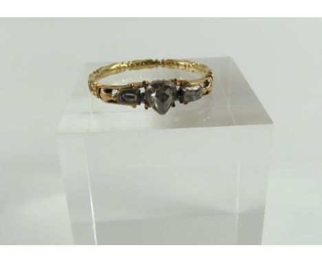 An early Georgian mourning ring, the central rose cut diamond pear shaped, with a rectangular shaped diamond either side, all