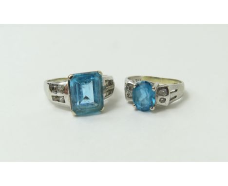 A white gold blue topaz and white stone dress ring, the step cut topaz with pairs of white stones set into the shoulders, fin