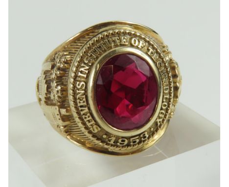 An American college ring, set with an oval facetted synthetic ruby, the synthetic ruby approximately 3.14ct, of typical form,