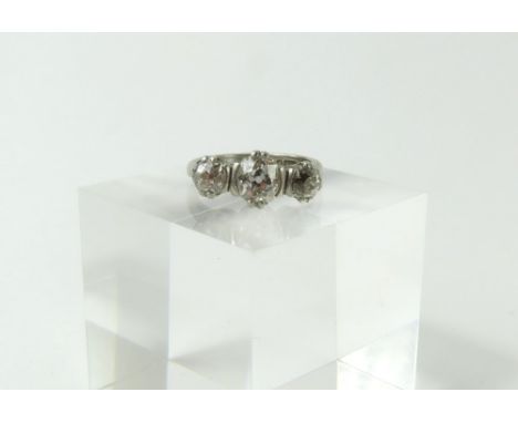 A platinum old cut diamond three stone ring, the graduated stones in double claw and half rub over settings, diamond total we
