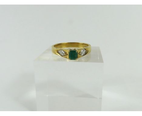An 18ct gold emerald and diamond dress ring, the square shaped step cut emerald in a four claw setting, approximately 0.32ct,