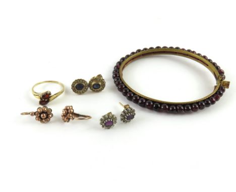 A garnet bead bangle on gold plated metal and with synthetic ruby push button clasp; a two stone garnet ring marked '9ct', fi
