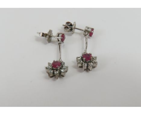 A pair of mid-20th century ruby and diamond drop earrings, a single round ruby claw set to a stud fitting with a bar drop bel
