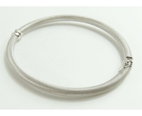 A textured white gold hinged bangle, marked '750', internal diameter 6cm, 6g gross, cased
