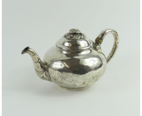 A Danish silver teapot with decorative engravings on the body and handles, and with floral shapes below a flower finial, poss
